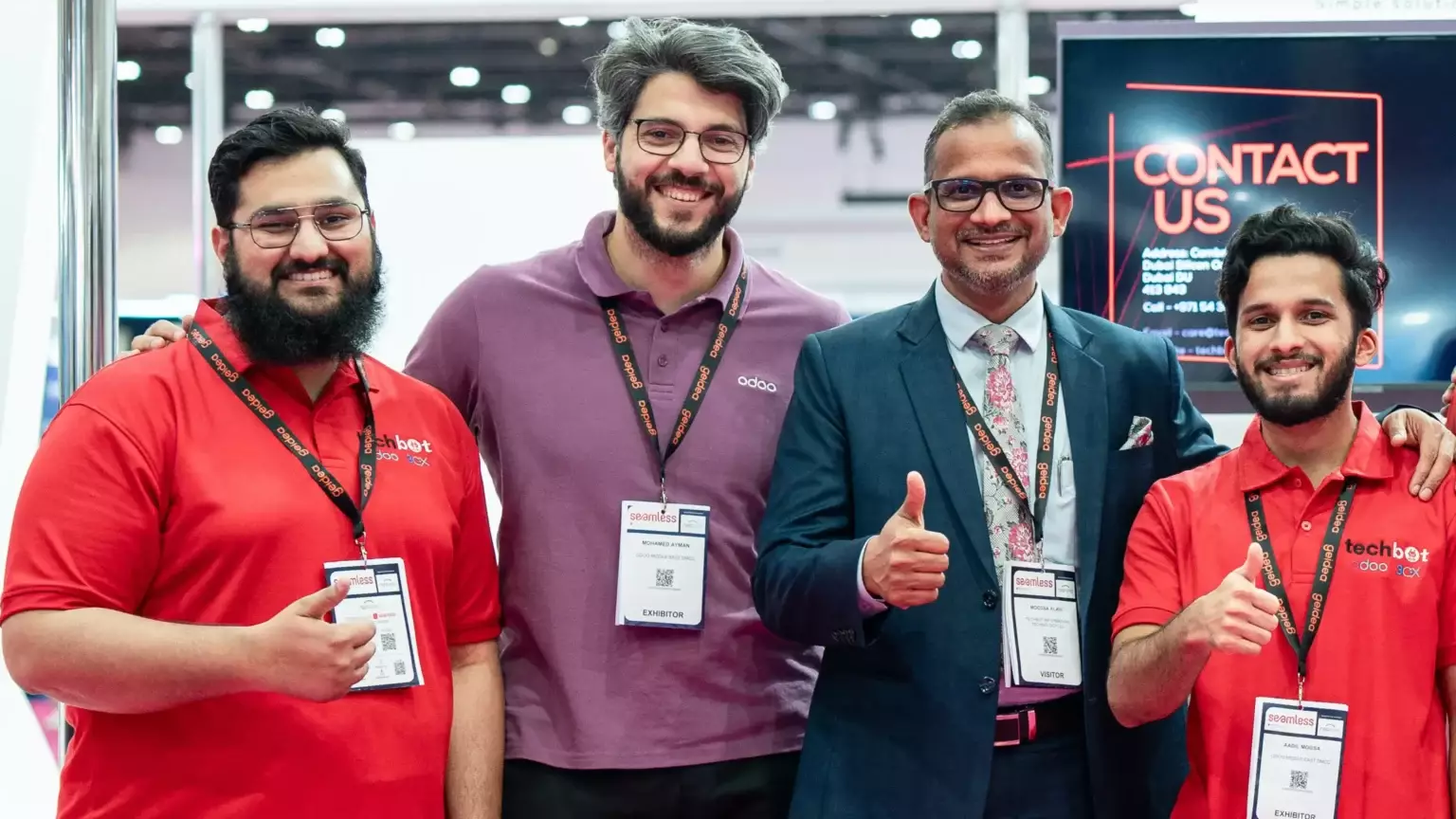 Techbot ERP team posing at the Odoo Business Show 2025 in Dubai, showcasing their ERP solutions for manufacturing, logistics, insurance, and more.